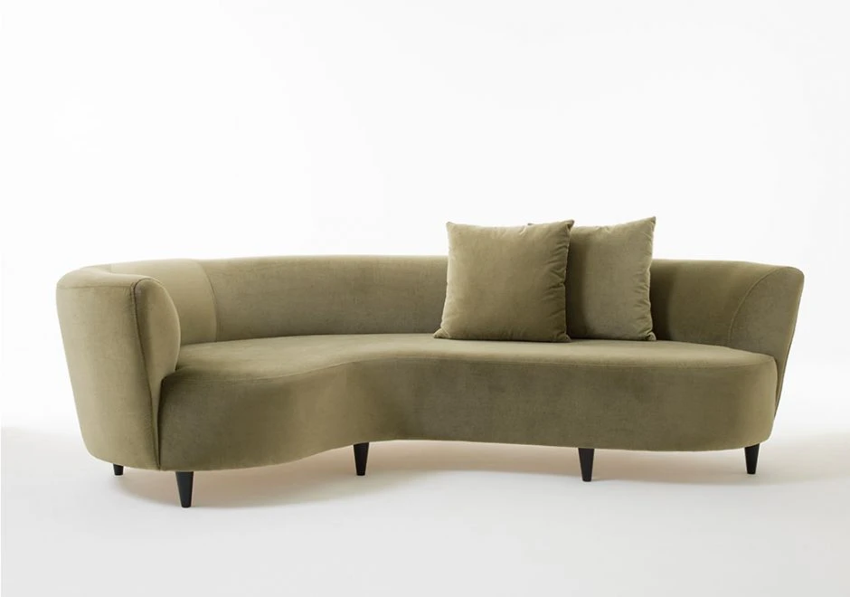 sofá curvo escuro com duas almofadas e cinco pés escuros em um fundo branco.