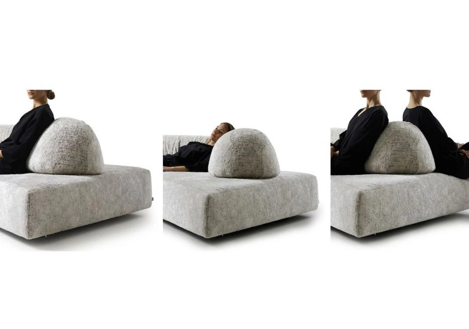 Detalhes de encosto de sofá de design moderno, com estofado em tecido cinza.