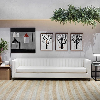 Sofá de design em ondas, com estrutura de madeira, pés em metal, estofado em tecido branco, visto de frente, em uma sala moderna.