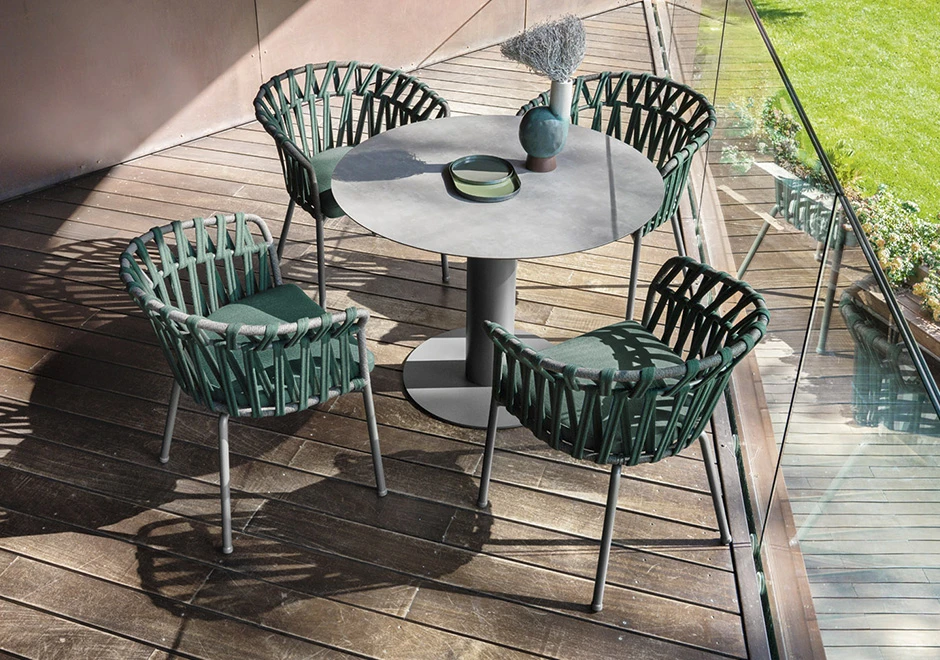 Quatro cadeiras assinadas com estrutura de alumínio com pintura eletrostática; encosto com fita em tecido impermeável trançada à mão. Almofada de assento estofada em tecido verde.