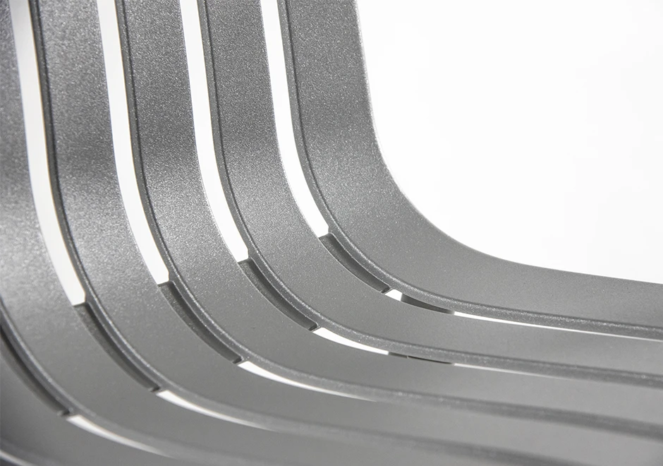 Detalhe aproximado de cadeira empilhável, com estrutura de alumínio pintado em poliéster na cor branco.