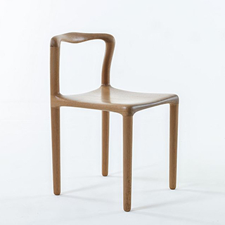 Cadeira assinada de madeira Tauari natural, vista de lado, em um fundo branco.