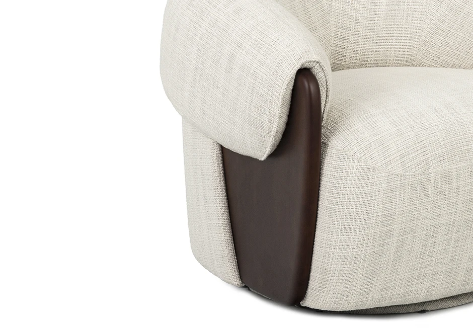 Detalhe do braço da poltrona Orca, evidenciando o estofado macio em tecido claro e o elegante acabamento em madeira escura, que adiciona sofisticação ao design.